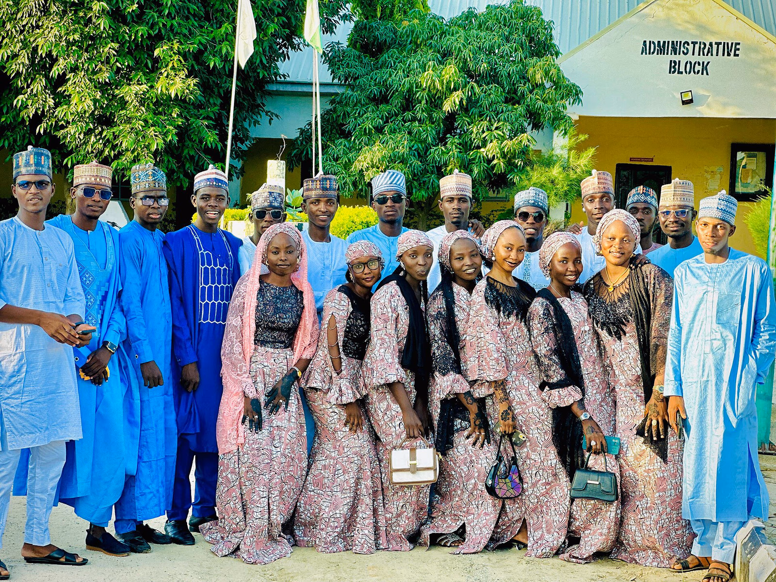 A group portrait taken outdoors likely at a school or institutional setting