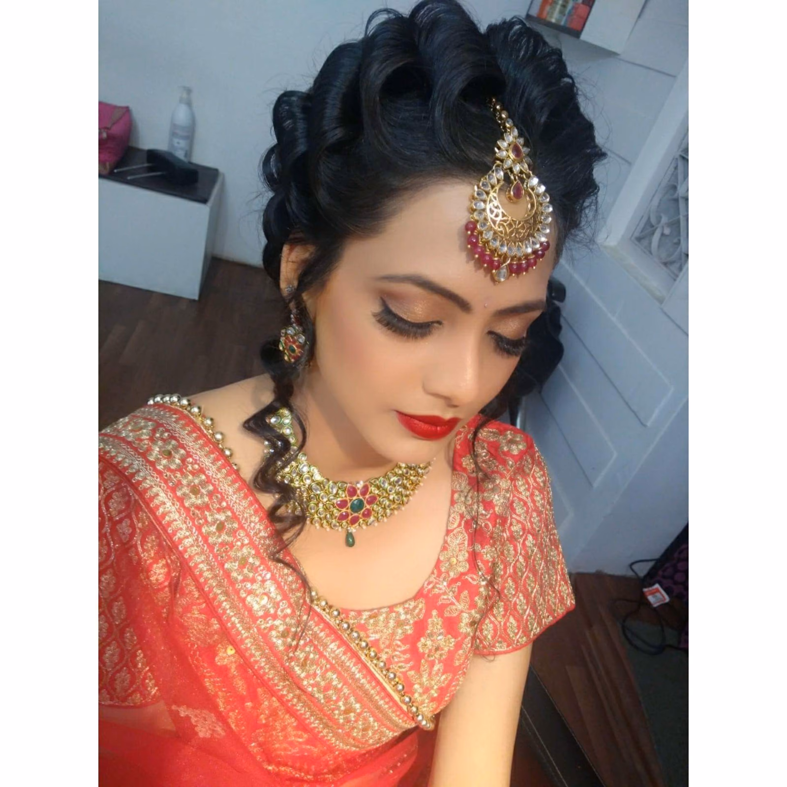 A bride having her makeup applied before the ceremony