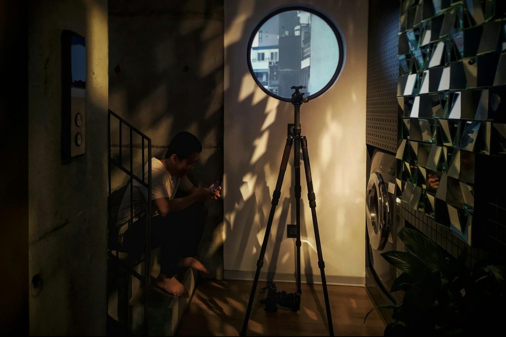 Stylish interior featuring a tripod, washing machine, and unique lighting in Hanoi, Vietnam.